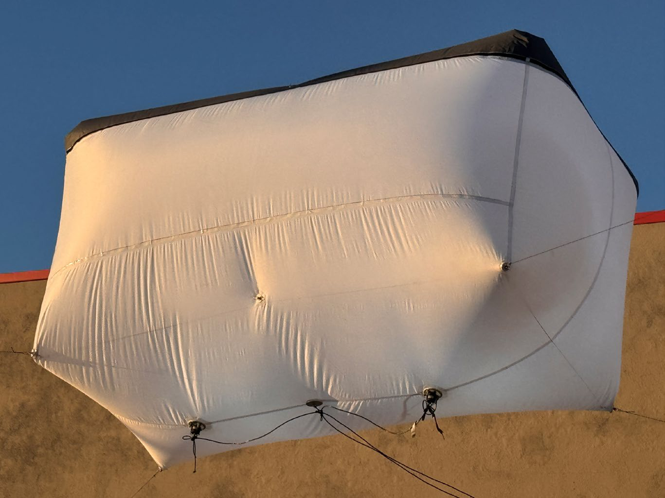Close-up underside view of a lighting balloon showing RF-welded seams and rigging points