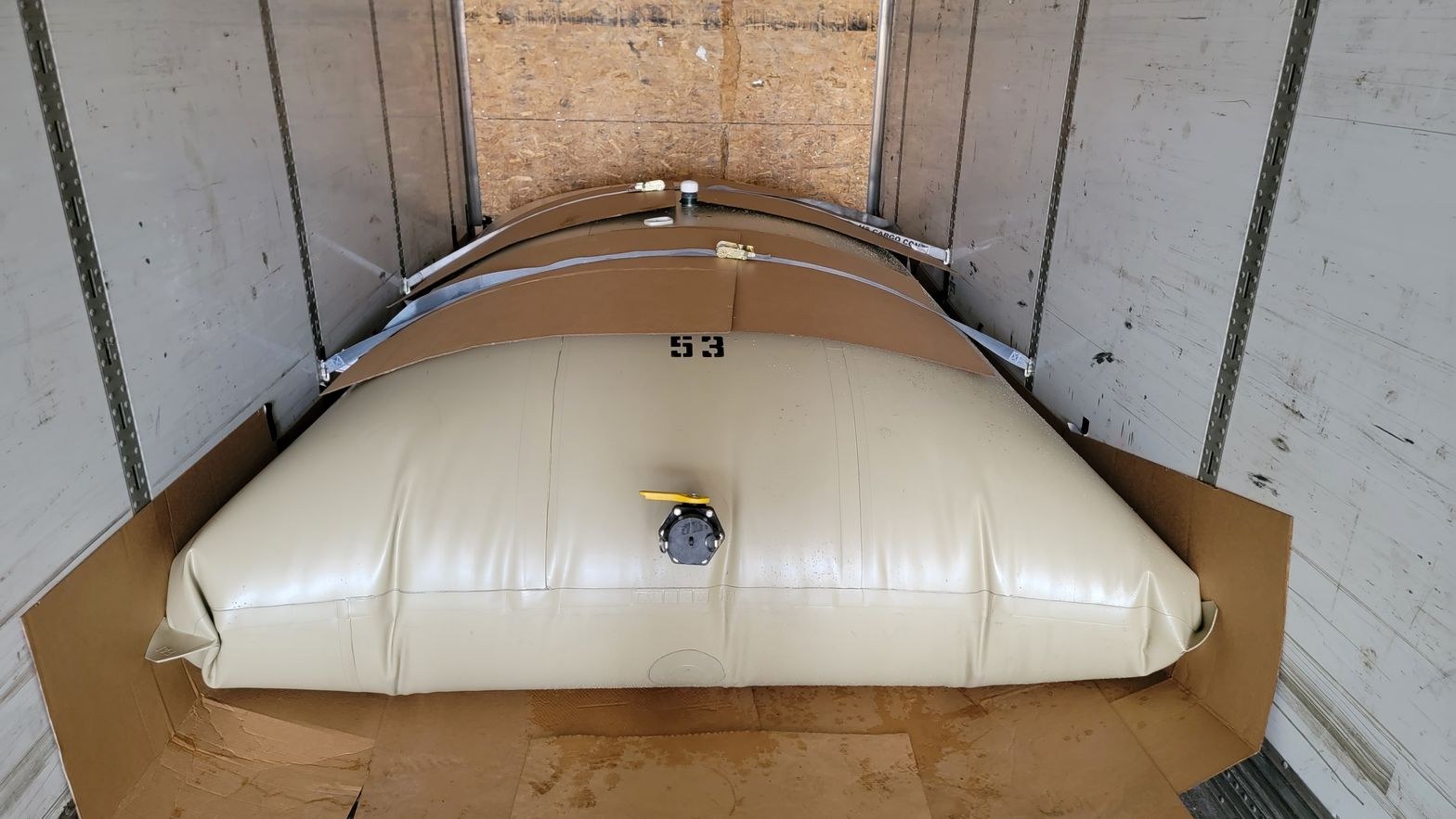 Filled Road Warrior transport flexitanks seated end to end inside a box trailer