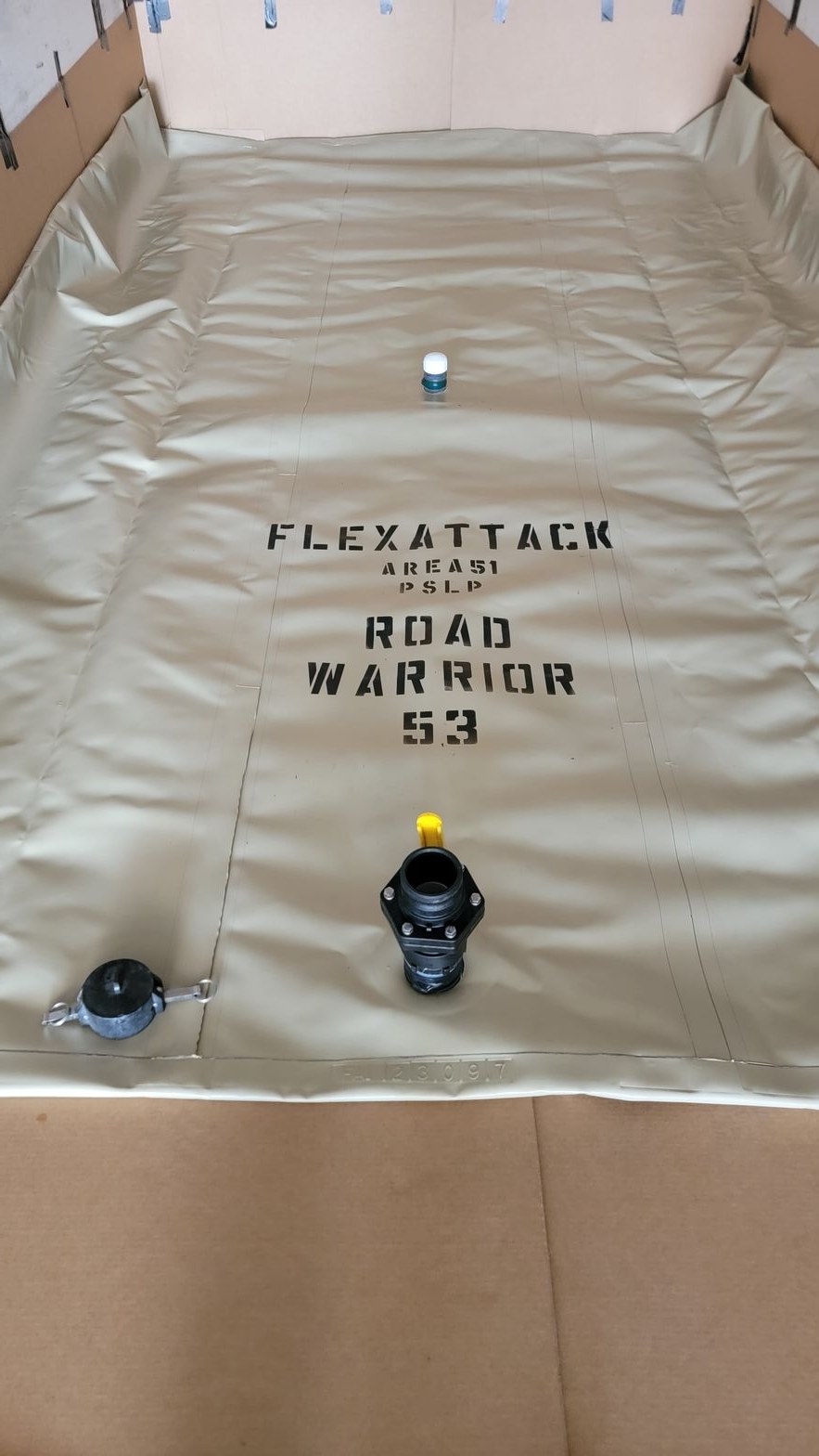 Stencilled unit markings and fill fittings on a flat-laid Road Warrior transport flexitank