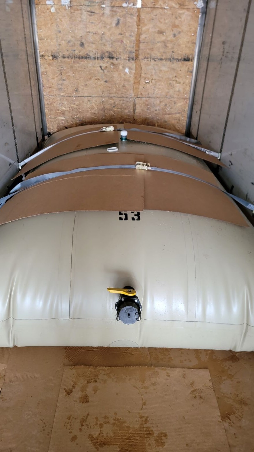 Discharge valve and camlock fitting on the face of a filled transport flexitank